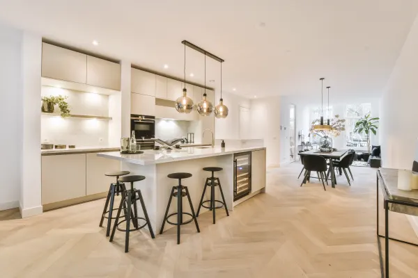 Waterproof herringbone patterned flooring planks in a bright modern kitchen