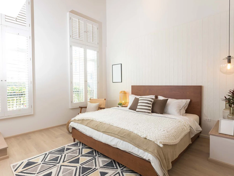Stylish scandinavian bedroom with light wood flooring