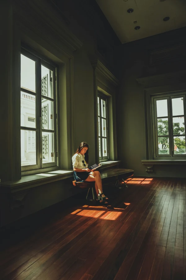 Girl reading in an open heritage home with Engineered Hardwood floors