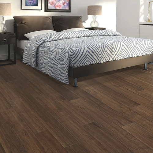 Bedroom with brown hardwood flooring