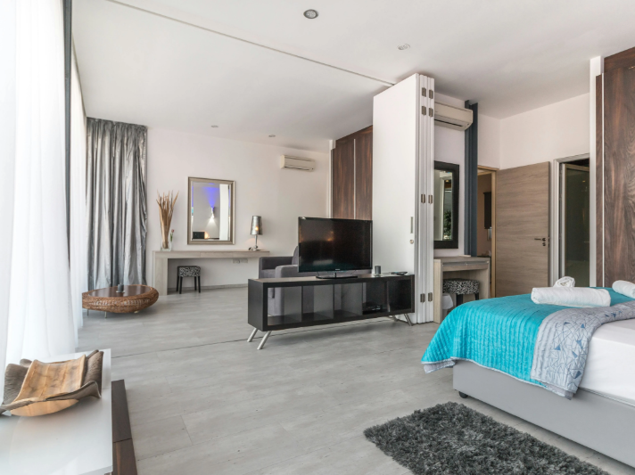 California home with bright bedroom and grey LVP floors