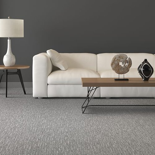 Grey carpet flooring in a San Diego living room with a white sofa