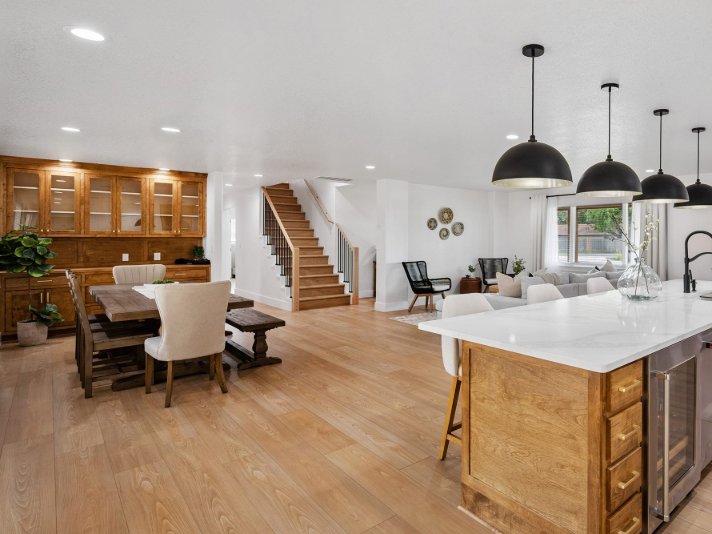 Character home with wire brushed hardwood flooring in a bright kitchen