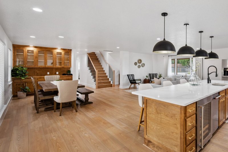 Character home with wire brushed hardwood flooring in a bright kitchen